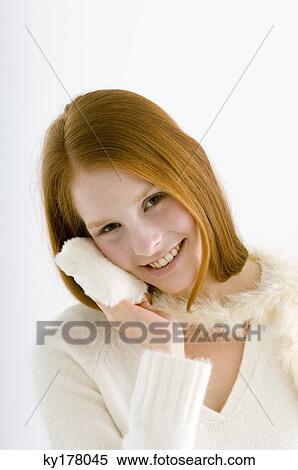 Portrait of a young woman applying face powder View Large Photo Image Stock Photography - Portrait of a young woman applying face powder. Fotosearch
