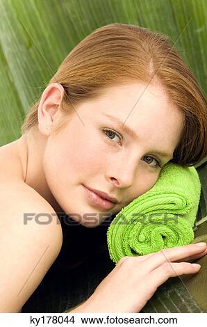 Portrait of a young woman lying on a massage table View Large Photo Image Picture - Portrait of a young woman lying on a massage table. Fotosearch