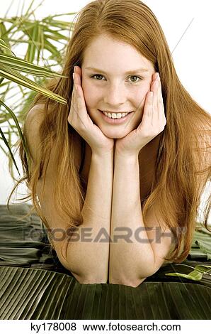 Portrait of a young woman lying on banana leaves and smiling View Large Photo Image Stock Photo - Portrait of a young woman lying on banana leaves and smiling. Fotosearch