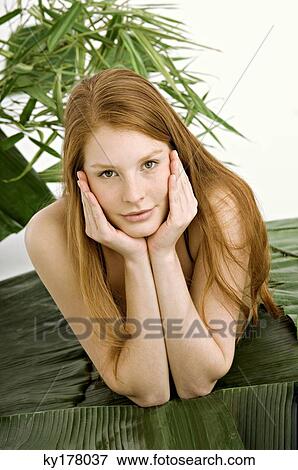 Portrait of a young woman lying on banana leaves View Large Photo Image Stock Photo - Portrait of a young woman lying on banana leaves. Fotosearch