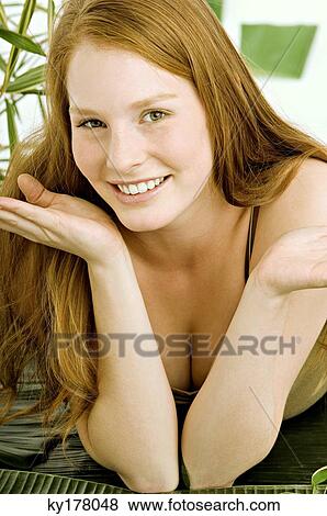 Portrait of a young woman lying on banana leaves and smiling View Large Photo Image Stock Photo - Portrait of a young woman lying on banana leaves and smiling. Fotosearch