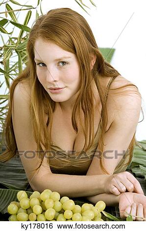 Portrait of a young woman lying on banana leaves View Large Photo Image Stock Photograph - Portrait of a young woman lying on banana leaves. Fotosearch