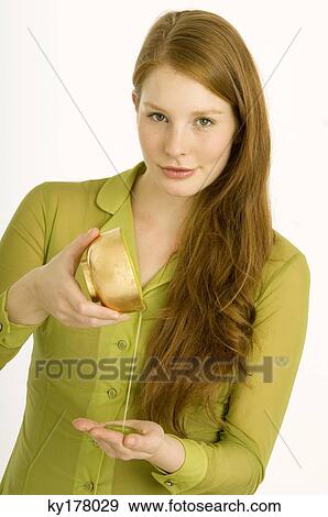 Portrait of a young woman pouring massage oil on her palm View Large Photo Image Stock Photo - Portrait of a young woman pouring massage oil on her palm. Fotosearch