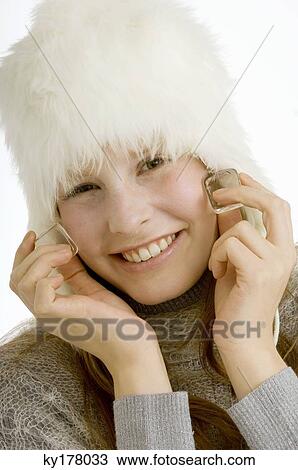 Portrait of a young woman touching ice cubes on her cheeks and smiling View Large Photo Image Stock Image - Portrait of a young woman touching ice cubes on her cheeks and smiling. Fotosearch