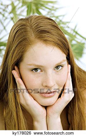 Portrait of a young woman with her head in her hands View Large Photo Image Stock Photograph - Portrait of a young woman with her head in her hands. Fotosearch