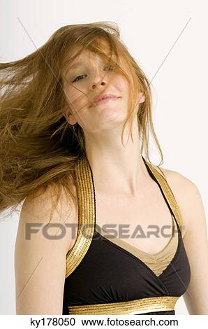 Stock Image - Portrait of a young woman with tousled hair. Fotosearch