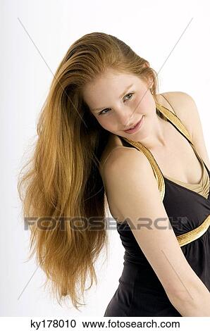 Side profile of a young woman smiling View Large Photo Image Stock Image - Side profile of a young woman smiling. Fotosearch