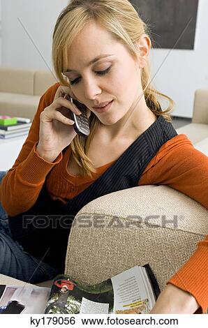 Stock Photograph - Close-up of a young woman talking on a mobile phone. Fotosearch
