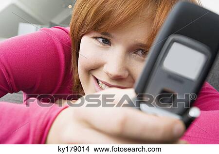Close-up of a young woman using a mobile phone View Large Photo Image Picture - Close-up of a young woman using a mobile phone. Fotosearch