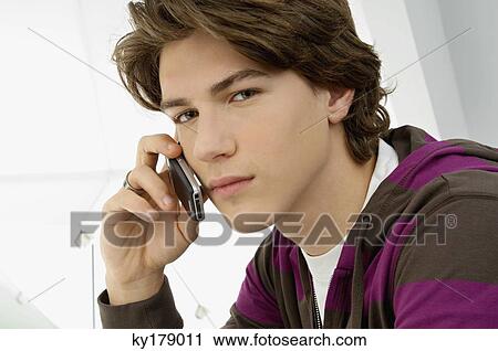 Portrait of a teenage boy talking on a mobile phone View Large Photo Image Stock Image - Portrait of a teenage boy talking on a mobile phone. Fotosearch
