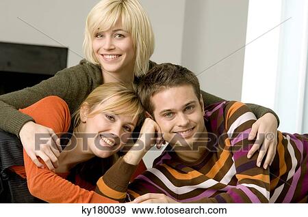 Portrait of a young man smiling with two young women View Large Photo Image Stock Photo - Portrait of a young man smiling with two young women. Fotosearch