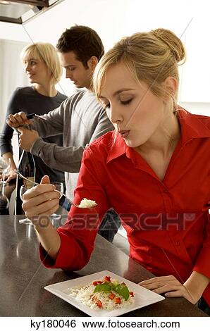 Young woman eating rice with a fork View Large Photo Image Stock Photograph - Young woman eating rice with a fork. Fotosearch