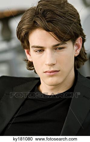 Close-up of a teenage boy looking down View Large Photo Image Stock Image - Close-up of a teenage boy looking down. Fotosearch