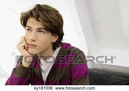 Close-up of a teenage boy looking serious View Large Photo Image Stock Photograph - Close-up of a teenage boy looking serious. Fotosearch