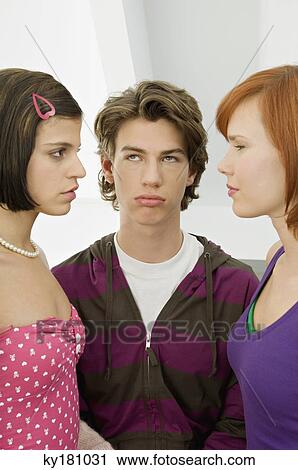 Close-up of a teenage boy standing with two young women View Large Photo Image Stock Image - Close-up of a teenage boy standing with two young women. Fotosearch
