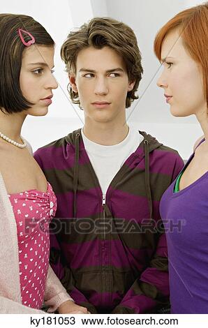 Close-up of a teenage boy standing with two young women View Large Photo Image Stock Image - Close-up of a teenage boy standing with two young women. Fotosearch