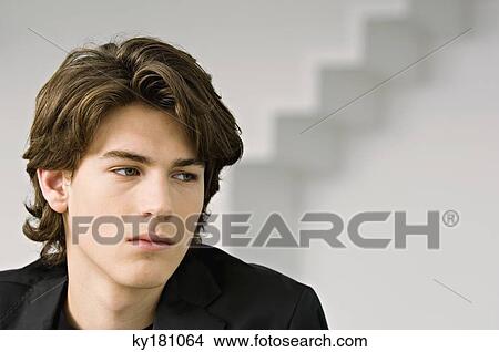Close-up of a teenage boy thinking View Large Photo Image Picture - Close-up of a teenage boy thinking. Fotosearch