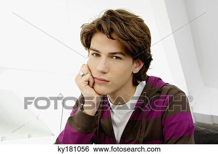 Portrait of a teenage boy looking serious View Large Photo Image Stock Photograph - Portrait of a teenage boy looking serious. Fotosearch