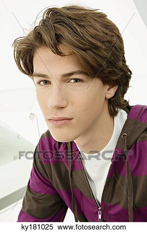 Portrait of a teenage boy looking serious View Large Photo Image Stock Photography - Portrait of a teenage boy looking serious. Fotosearch