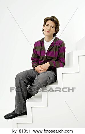 Portrait of a teenage boy sitting on steps and smiling View Large Photo Image Stock Image - Portrait of a teenage boy sitting on steps and smiling. Fotosearch