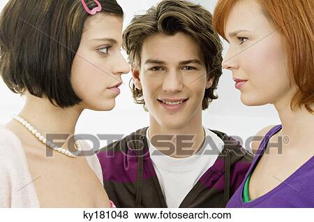 Portrait of a teenage boy smiling with two young women View Large Photo Image Stock Photo - Portrait of a teenage boy smiling with two young women. Fotosearch