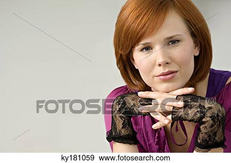 Stock Photo - Portrait of a young woman smirking. Fotosearch