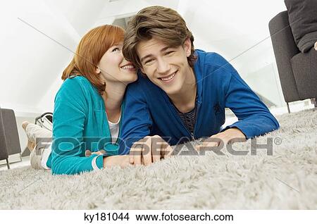 Picture - Portrait of a young woman whispering to a teenage boy. Fotosearch