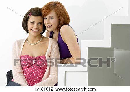 Portrait of two young women sitting on steps and smiling View Large Photo Image Stock Image - Portrait of two young women sitting on steps and smiling. Fotosearch