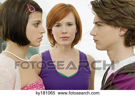 Side profile of a teenage boy with two young women View Large Photo Image Stock Photography - Side profile of a teenage boy with two young women. Fotosearch