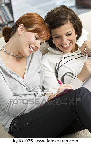 Two young women studying View Large Photo Image Stock Photography - Two young women studying. Fotosearch