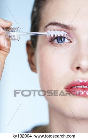 Woman applying mascara View Large Photo Image Picture - Woman applying mascara. Fotosearch