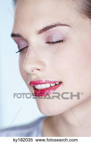 Stock Photography - Young woman with eyes closed. Fotosearch