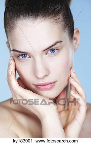 Portrait of young woman with hands on cheeks View Large Photo Image Stock Image - Portrait of young woman with hands on cheeks. Fotosearch