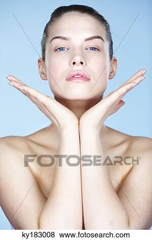 Portrait of young woman with hands on chin View Large Photo Image Stock Photo - Portrait of young woman with hands on chin. Fotosearch