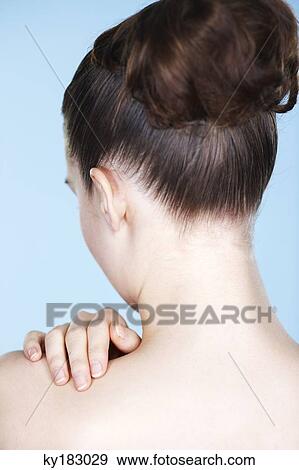 Woman touching her shoulder, rear view View Large Photo Image Stock Photo - Woman touching her shoulder, rear view. Fotosearch