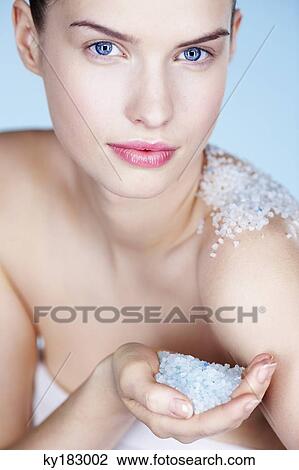 Young woman rubbing her shoulder with salt View Large Photo Image Stock Image - Young woman rubbing her shoulder with salt. Fotosearch