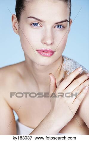 Young woman rubbing her shoulder with salt View Large Photo Image Stock Photo - Young woman rubbing her shoulder with salt. Fotosearch