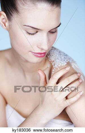 Young woman rubbing her shoulder with salt View Large Photo Image Stock Photograph - Young woman rubbing her shoulder with salt. Fotosearch
