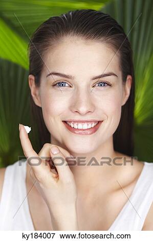 Portrait of young woman with sun cream on her finger View Large Photo Image Stock Photo - Portrait of young woman with sun cream on her finger. Fotosearch