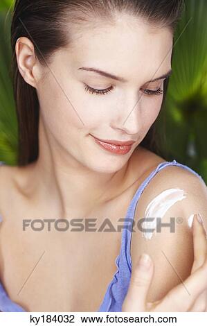 Young woman applying sun cream View Large Photo Image Stock Image - Young woman applying sun cream. Fotosearch