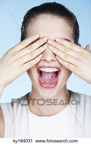 Young woman covering eyes View Large Photo Image Stock Image - Young woman covering eyes. Fotosearch