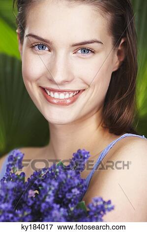 Young woman holding lavender sprigs View Large Photo Image Stock Photo - Young woman holding lavender sprigs. Fotosearch