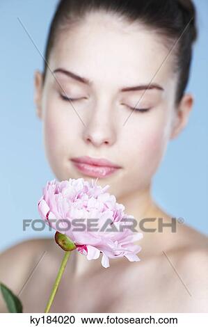 Young woman holding peony View Large Photo Image Stock Image - Young woman holding peony. Fotosearch