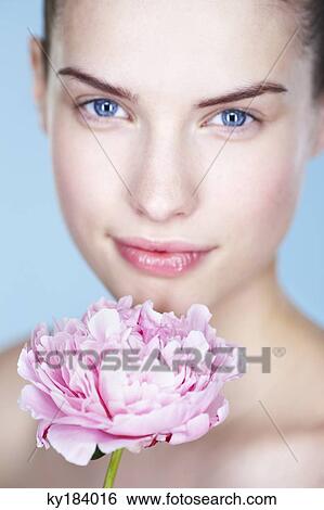 Young woman holding peony View Large Photo Image Stock Photograph - Young woman holding peony. Fotosearch