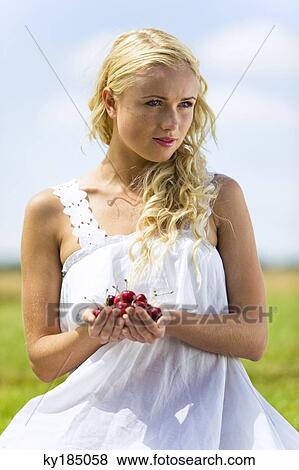 Portrait of young woman with cherries View Large Photo Image Stock Photo - Portrait of young woman with cherries. Fotosearch