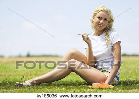 Young woman eating grated carrots View Large Photo Image Stock Photograph - Young woman eating grated carrots. Fotosearch