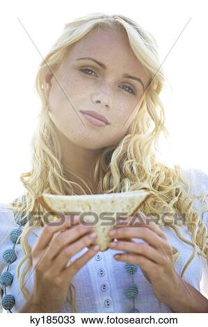 Young woman holding a sandwich View Large Photo Image Stock Image - Young woman holding a sandwich. Fotosearch