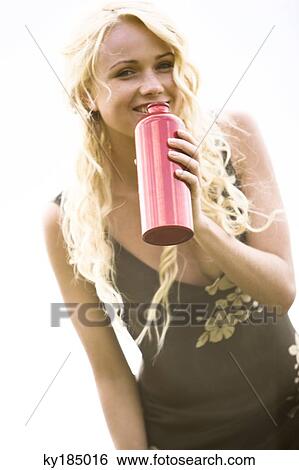 Young woman holding a thermos bottle View Large Photo Image Stock Photograph - Young woman holding a thermos bottle. Fotosearch