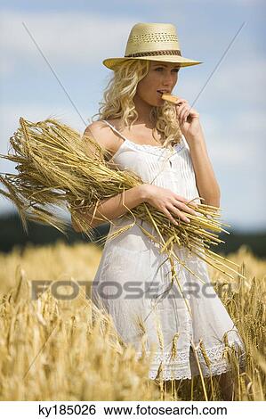 Young woman in a wheat field View Large Photo Image Stock Photograph - Young woman in a wheat field. Fotosearch