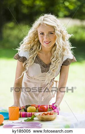 Young woman posing for the camera, holding tomatoes on a tray View Large Photo Image Stock Photography - Young woman posing for the camera, holding tomatoes on a tray. Fotosearch